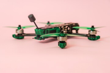 Close up view on modern drone with camera isolated on pink background