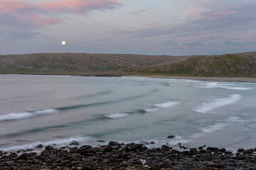 Waves of Barents Sea rolling to the shore on a beautiful summer night. Berlevåg, Finnmark, Northern Norway
