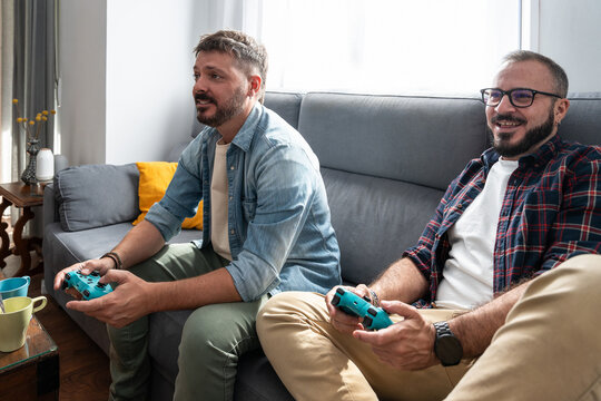 Gay couple enjoying a relaxed gaming session at home