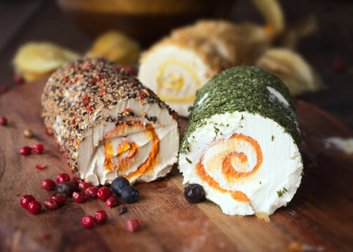 Spiced cheese rolls decorated with herbs and seeds