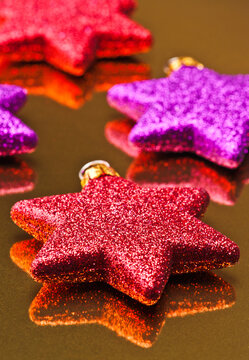 Vibrant Christmas stars on a golden backdrop
