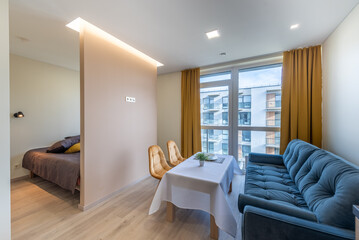 Modern Studio Apartment Interior Design With Bright Windows and Cozy Furniture. Home Interior