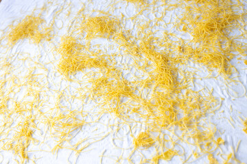Homemade Pasta Noodles Drying on Floured White Background