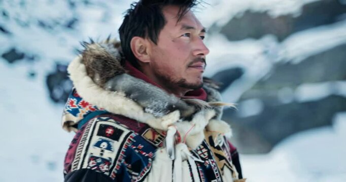 The portrait of a Greenlander dressed in traditional clothing represents a deep connection to the Arctic landscape and rich Inuit traditions