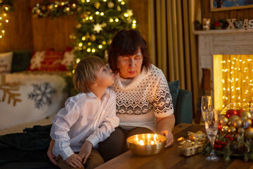 Happy family on Christmas, enjoying some quality time together, kids and adults with pet dog on Christmas eve