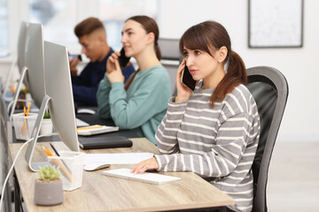 Sales department. People calling to clients in office, selective focus