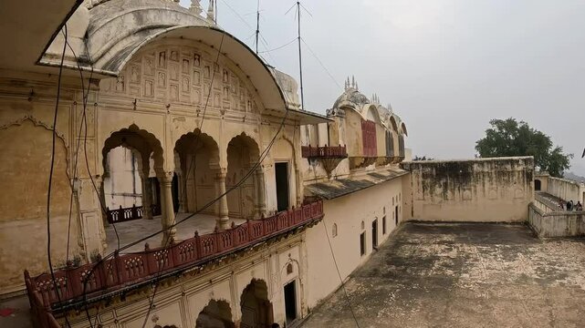 Alwar Fort courtyard overlooking misty mountains on a cloudy day