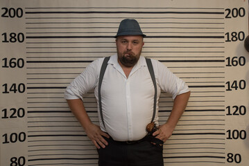Gangster Party, A man dressed in classic gangster attire, featuring a white shirt, suspenders, and...