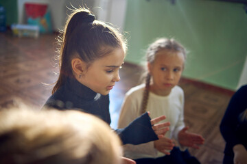 a group of pre-teens perform a teacher's task during an acting class, communication in a circle