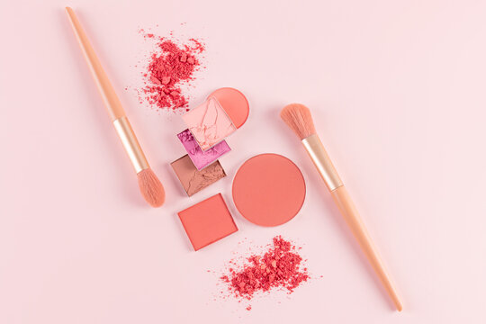 Flat lay of blushes and brushes on a soft pink background