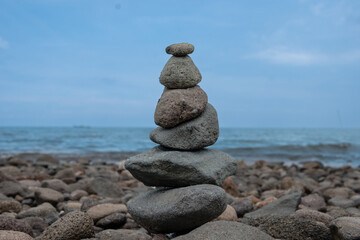 Serene Seascape: A Balanced Rock Cairn by the Ocean