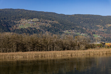 Austrian lake Ossiacher See in Carinthia with the village of Ossiach and the Alps in the background in autumn
