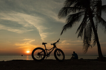 Silhouette of a bicycle on the beach