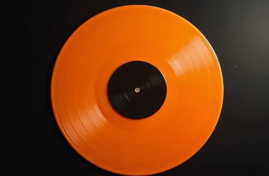 Bright orange vinyl record with a black center label on a sleek black background, showcasing vibrant retro audio aesthetics