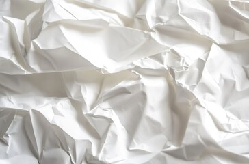 Obraz premium A close-up of crumpled white paper, emphasizing the texture and depth in a monochromatic setting.