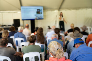 farmers at a field day learning on a farm. learning about agriculture and innovation listen to experts. farming community together in for a growers field day talking to agronomist