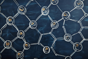 Detailed chalk drawing of molecular structures illustrating chemical compounds on a blackboard in a classroom setting