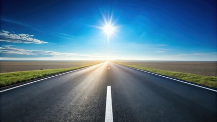 Naklejka premium Asphalt road vanishing into a bright sunlit horizon, flanked by grassy verges under a clear blue sky