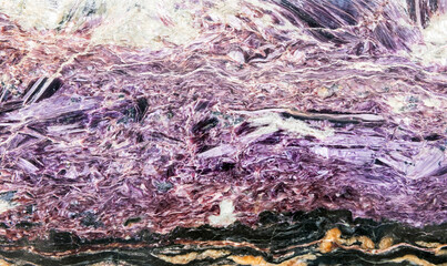 Charoite with a coarsely banded structure. Background texture