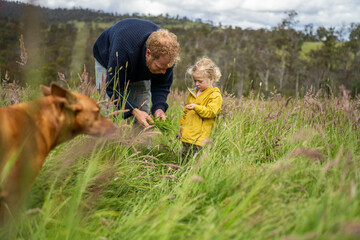 farming family together in a field regenerative organic farmer, taking soil samples and looking at...