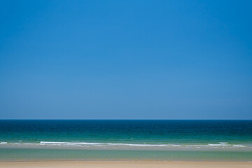 Beautiful seascape with blue sky on a sunny day. Nature background. Sea surface in sun light. Relaxing natural photo wallpaper. Teal blue ocean view. Breezy wavy seawater. Water background texture.