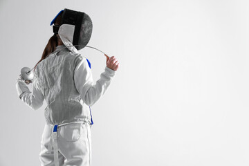 Fencer with epee on white background, space for text