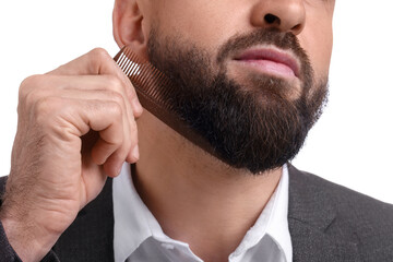 Man combing beard on white background, closeup
