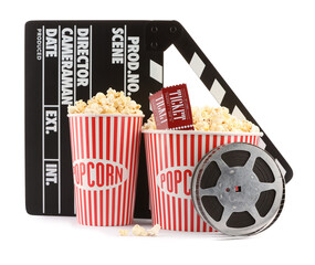 Tasty popcorn, film reel, clapper and movie tickets isolated on white
