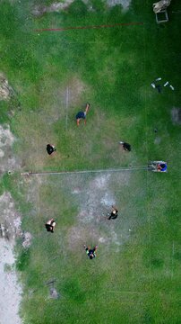 Aerial view of group of young men are playing takraw in the afternoon