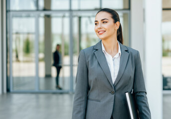 Confident Businesswoman Looking Away, Modern Office Building