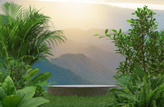 Concrete podium table top on grass outdoors with mountains golden sky at sunrise nature landscape background.placement pedestal present minimal stand display tropical forest concept.