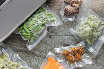 Vacuum packing sealer, different food in vacuum packings. Top view