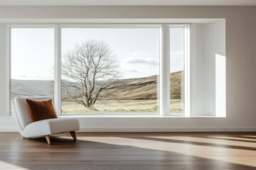 Fototapeta premium Natural light illuminates a minimalist room with a view of a tree and rolling hills