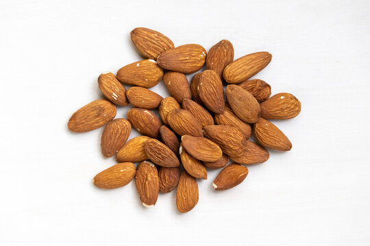 Fresh almonds isolated on a white background. A healthy food for life and a natural diet concept. Top view.