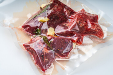 Beef Vacuumed with Rosemary cooked sous vide on a white background. High quality photo