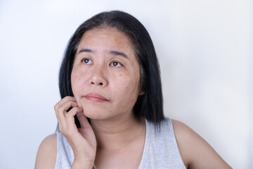 Woman with a thoughtful expression and worries about wrinkles on her face, sad eyes Uneven skin...