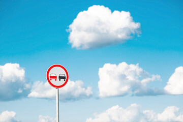 Traffic Laws. Attention. Overtaking is prohibited. A road sign on a metal pole against a background...