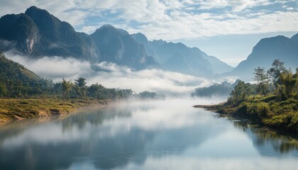 Stunning morning mist covering calm river in tropical landscape