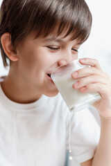 Cute baby drinking milk at home and smiling