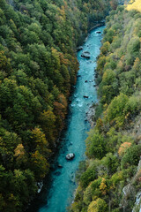 Beautiful blue mountain river Tara surrounded by green and yellow early autumn forest. Montenegro landscape, top view from Djurdjevica bridge.