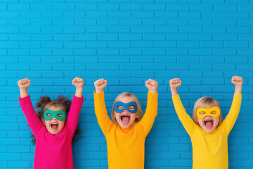 Three children in superhero masks are raising their fists. Organizing Kids’ Celebrations with ease and creativity