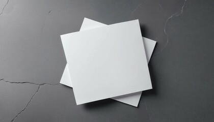 Flat lay of blank paper on a smooth gray stone surface