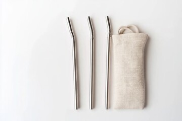 reusable stainless steel straw set arranged on white background with linen carry pouch