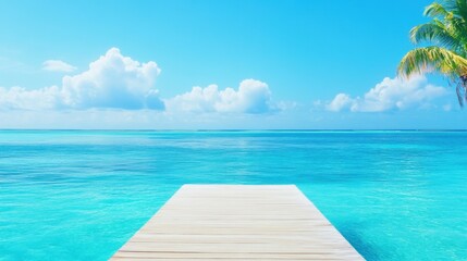 Wooden pier extending into clear blue tropical waters with a sunny sky and a palm tree