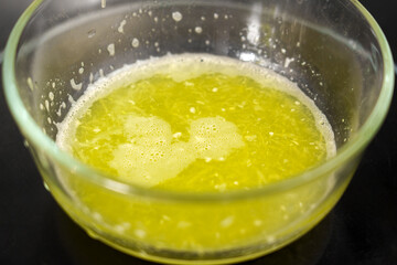 Freshly squeezed zucchini juice with light froth in glass bowl.