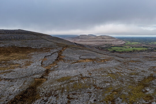 Aerial view of the Burren's limestone hills, featuring stone walls and hiking paths