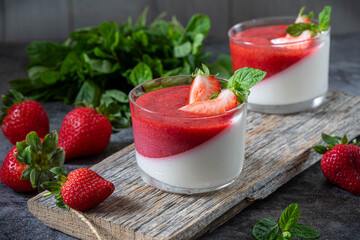 Panna Cotta. Italian dessert made with cream, milk and gelatin, topped with strawberry sauce.