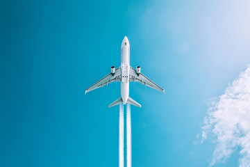 Fototapeta premium Plane soaring high, leaving a white trail