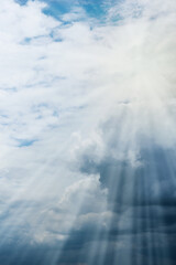 Fototapeta premium Storm clouds and the sun peeking out from under them. Cloudy landscape. Natural background. Simple background sky for poster or mock up. Soft focus.