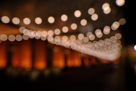 warm, magical, nostalgic, cozy, celebratory, and luxurious cinematic mood. The strong contrast between the dark background and bright bokeh makes the footage highly effective as a seasonal visual.